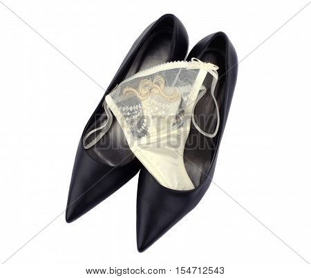 Silk panties and black leather shoes isolated on white background