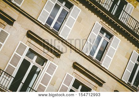 Close up exteriror of Parisian apartment windows.