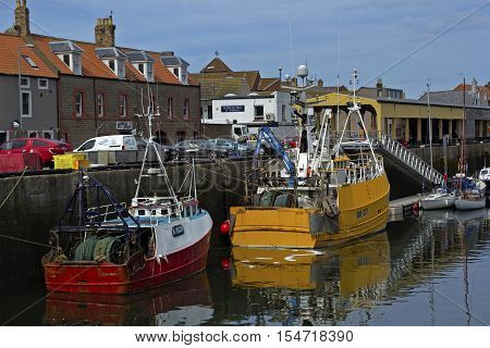 Boats and houses in Eyemouth old fishing town in Scotland UK. 07.08.2015