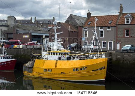 Boats and houses in Eyemouth old fishing town in Scotland UK. 07.08.2015