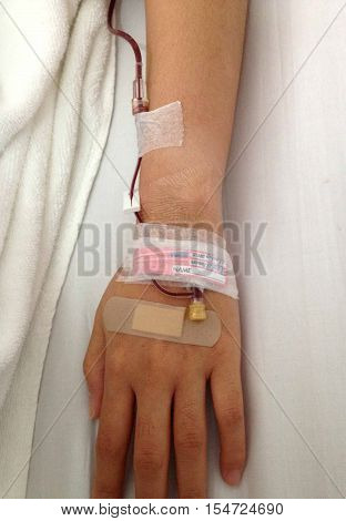 Blood transfustion via woman hand at hospital