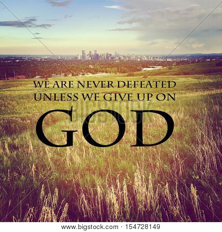 Inspirational quote. We are never defeated unless we give up on God.  Lighting and Instagram effects.