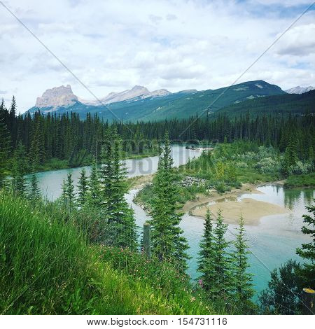 Scenic mountain landscape with river and trees in foreground.  Instagram effects.