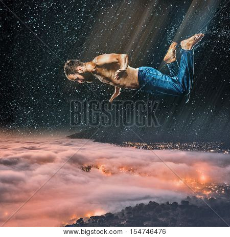 The male break dancer in water on dark background.