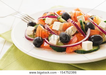 Classic greek salad. Salad with tomato cucumber red onion black olives and fresh feta cheese selective focus horizontal