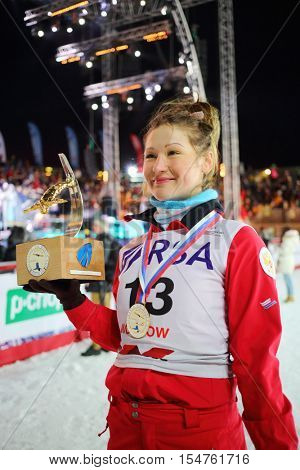 MOSCOW - FEB 13, 2016: Winner holds award at World Cup FIS Freestyle at night in Krylatskoye
