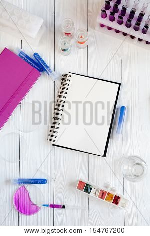 medical student working place with blank open notebook at wooden table top view