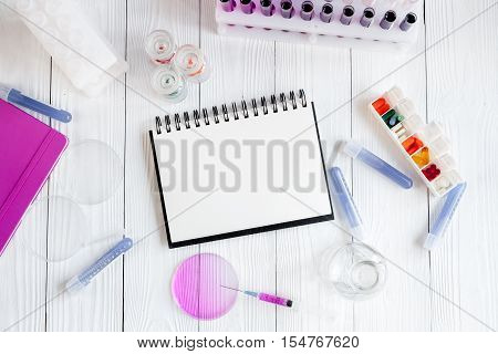 medical student working place with blank open notebook at wooden table top view