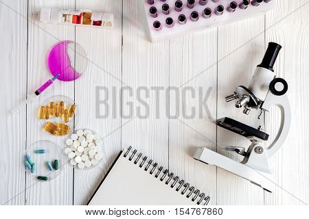workplace lab assistant with microscope at the clinic top view no one