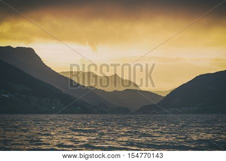 Beautiful view of the lake Resia. Dramatic sky and colorful sunset. Alps, Italy, Europe. Toned like Instagram filter