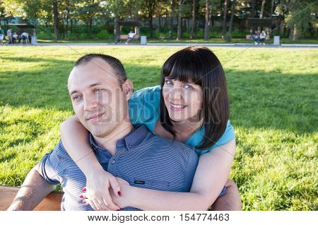 Woman hugging a man on the bench