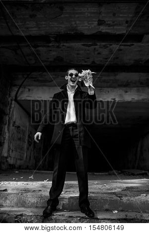 incredibly handsome guy holding a wad of paper