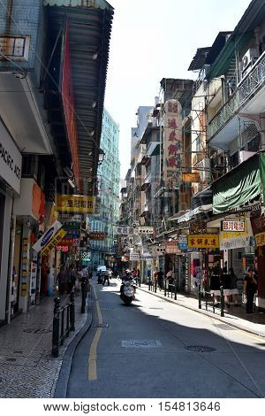 Macau China - Oct 28 2016. Narrow streets of Macau downtown. Macau is a popular tourist attraction of Asia in the holidays.