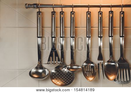 kitchen ware scoops and shovels hang on a railing