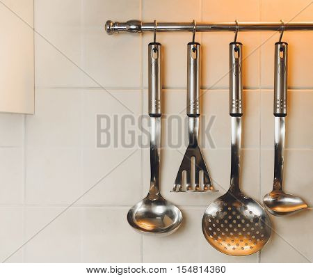 kitchen ware scoops and shovels hang on a railing