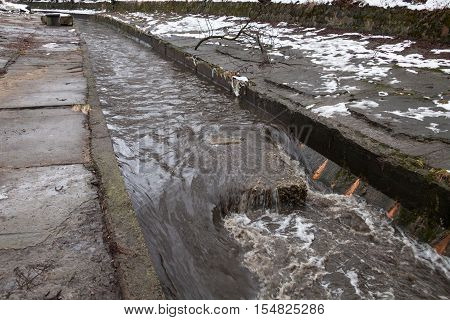 Urban stream in winter. The Lybid river in Kyiv.