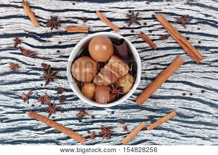 Thai Recipes : Stewed boiled egg with tofu and streaky pork ,call Khai Palo in Thai, take photo with herbs as Chinese star anise ,cinnamon,black pepper,cilantro roots and stems