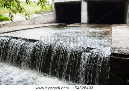 Water stream flowing out the underground tunnel into the Lybid river in Kyiv.