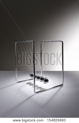 Chrome balancing spheres know as Newton's Cradle (pendulum)