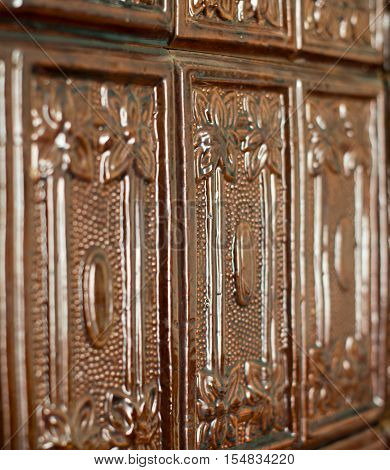 Brown tiles on the stove surface. Close up.