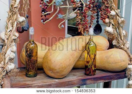 Two pumpkins garlic bundles vegetables and alcohol tinctures on medicinal herbs in bottles