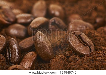 Close Up Of Coffee Beans Over Grained Coffee