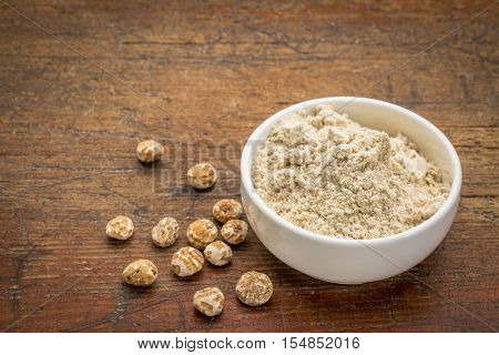 organic tiger nuts, a rich source of resistant starch - peeled nuts and powder for smoothies