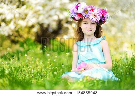 Adorable Little Girl In Blooming Cherry Garden