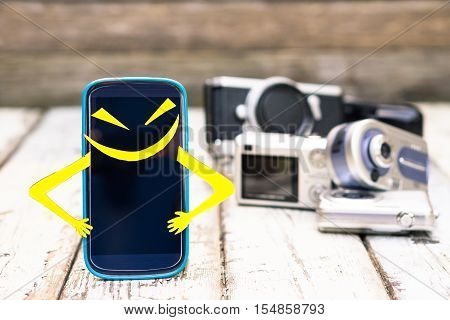 New mobile smart phone superhero with funny expression of pride standing on wood with old cameras background - Telephone vs entry level cameras - Marketing and sales concept of photography devices