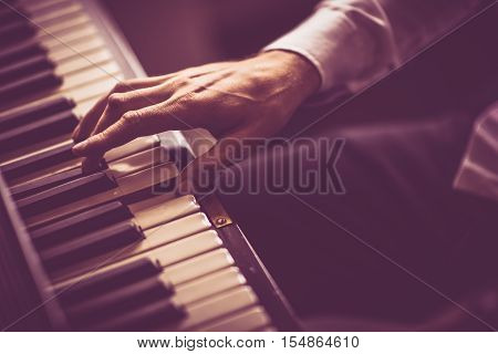 The Piano Player. Male Hand on the Piano Closeup Photo.