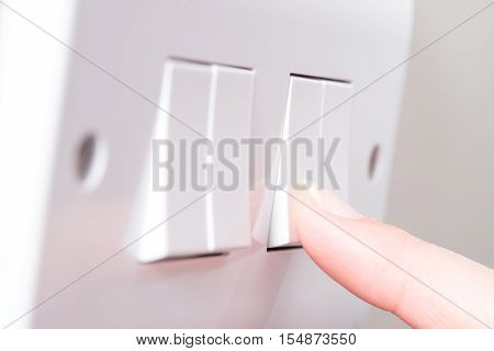 Finger Switching On Light On Wall