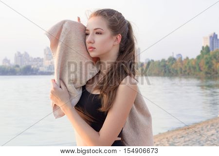 Young Pretty Slim Fitness Sporty Woman Rests And Wipes Herself With Towel During Training Workout Ex