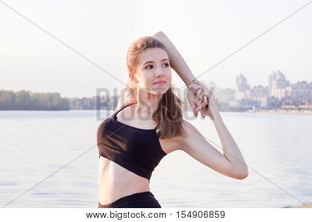 Young Fitness Woman Stretches Preparing For Training Workout Exercises Outdoor
