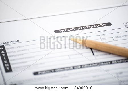 Patient information form and pen on deskMedical questionnaire