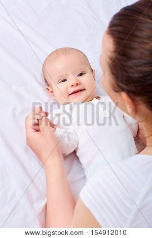 Рappy Mother With Baby On The Bed.smiling,laughing, Happiness,playing.