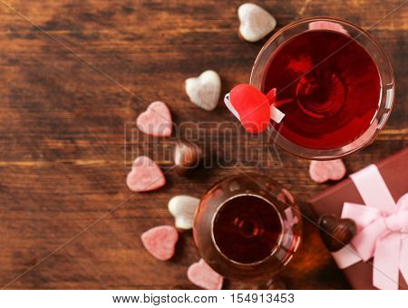 Alcoholic drinks for the festive party. Chocolate candy hearts. Gift for a holiday. Date on Valentines Day