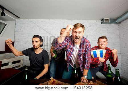Friends Sprot Watching On Tv, Have Fun, Eat Pizza. Friends To Eat Pizza, Drink Alcohol, Shout And La