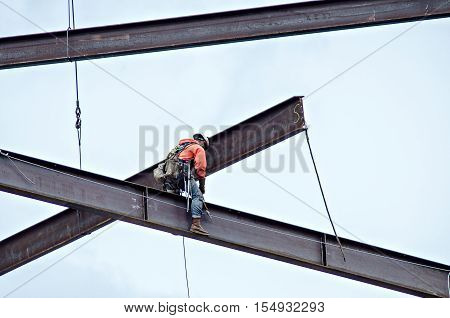 a construction worker working on highrise building
