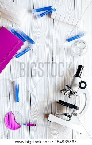 doctor workplace at wooden table with microscope in lab top view no one