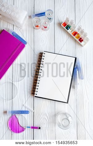 medical student working place with blank open notebook at wooden table top view