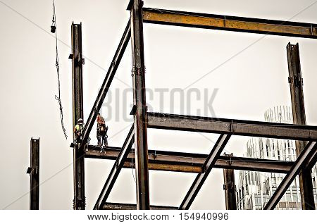 Construction Worker Working On Highrise Building