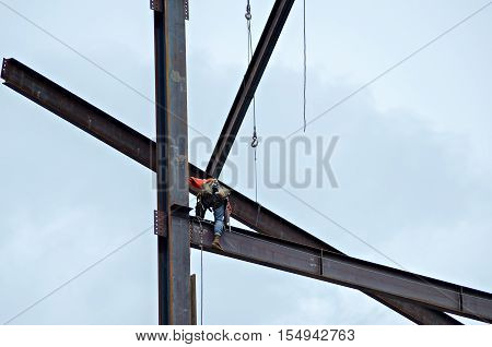 Construction Worker Working On Highrise Building