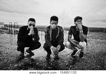 Three Rap Singers Band On The Roof. Black And White Photo