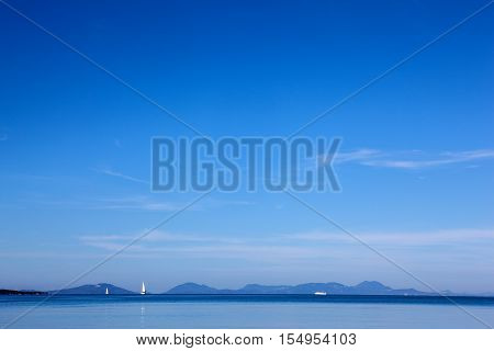white yacht traveling at sea against a blue sky in a calm sea