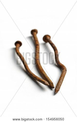 Crooked and rusty nails on a white background
