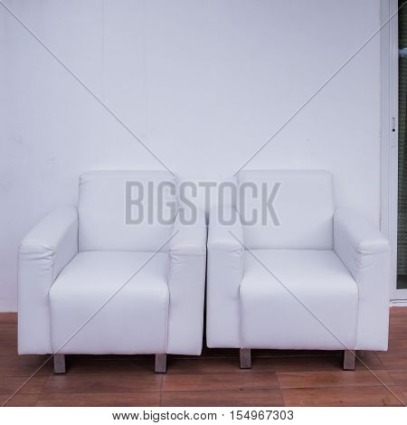 Living room with sofa in front of a wall in white