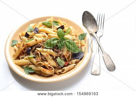 asta with meat and basil on a plate on a white background