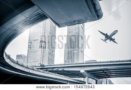 blurred street scene in city with a plane flying over in city of China.