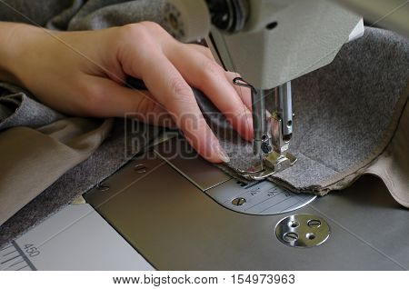 Close-up shows how to work in the studio on tailoring.