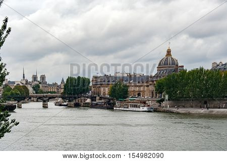 PARIS, FRANCE, MAY 16 2005. Bridge of arts, before fashion put padlocks on railings. In the background the Mazarine Library with the Academy of Fine Arts . View from the Sena River